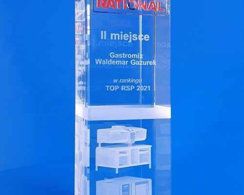 Rational's glass seller of the year award. A crystal cuboid with an engraved 3D model of a catering device Rational logo sandblasted and painted in blue and red A unique custom-made statuette that combines three glass decorating techniques 3D engraving, sandblasting and spray painting Versatile device for the restaurant as a 3D model very precisely engraved in a block of crystal glass