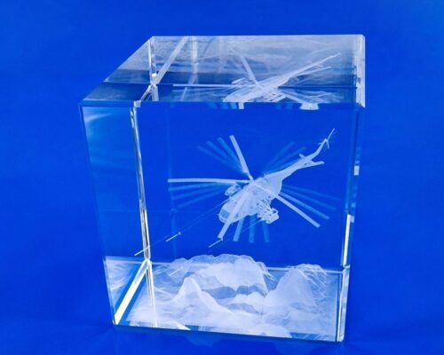 award Mi-17 helicopter shooting over the mountains, 3D helicopter design engraved in a block of crystal glass with a shooting effect A crystal with a 3D model as an elegant gift for a military commander